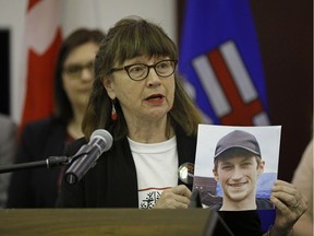 Lorna Thomas holds a photo of her son Alex Thomas at the Alberta legislature on Wednesday, May 31, 2017. Alex's death in 2012 was related to drug dependence.