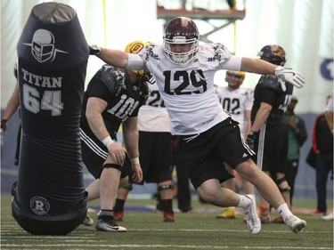 McMaster defensive lineman Mark Mackie (129) breaks past Laurier offensive lineman Brett Golding during the 2017 Ontario Regional Combine for the  CFL at Varsity Stadium in Toronto on March 17, 2017.
