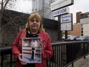 Marty Juknevic holds a picture of her daughter Amber Wilson at the location where Amber was last seen one year ago. Amber disappeared from Edmonton without a trace. Taken on May 15, 2017.