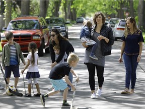 Masha Ribich (looking towards camera) is the organizer of a pilot project in the Westmount community of Edmonton to allow children to play safely on the streets in front of their homes. On June 3, 2017 part of 126 Street will be closed to vehicular traffic to allow children in the neighborhood to play in the street.