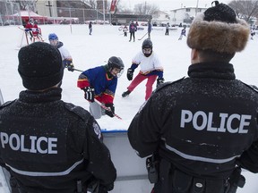 A 2015 photo shows members of the Edmonton Police Service and neighbourhood children taking part in the 7th Annual McCauley Cup at the McCauley Community Rink.