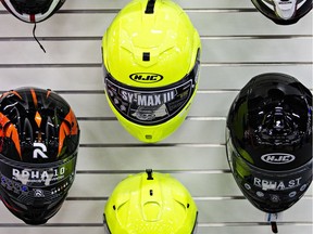 Helmets hang on a wall during set up for the 2015 Motorcycle and ATV Show Edmonton in Edmonton, Alta., on Thursday, Jan. 15, 2015. File photo.