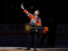 Brett Kissel reacts as fans at Rogers Place sing Star-Spangled Banner, prior to the Edmonton Oilers and Anaheim Ducks, in Edmonton Sunday, April 30, 2017. Kissel's microphone did not work and the fans filled in.