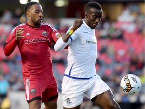Ottawa's Jamar Dixon tries to get the ball from Edmonton's Papé Diakité during first half action as the Ottawa Fury FC (red) met up with FC Edmonton during the first leg of the Canadian Championship at TD Place in Ottawa Wednesday, May 3, 2017.