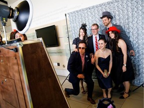 People take in the photo booth during the Mad Hatter's Gala at MacEwan University in Edmonton on Saturday, May 6, 2017.