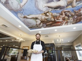 Pizza cook Chris Standing shows a clam pizza special at Vaticano Cucina in Edmonton on Friday, May 26, 2017.