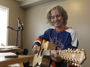 Rocko Vaugeois plays guitar in his apartment in Canora Place in Edmonton on Wednesday, April 26, 2017.
