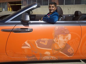 Ashif Mawji poses for a photo with his $350,000 Rolls Royce Dawn convertible with a Connor McDavid wrap on the side, in Edmonton on May 5, 2017. The car has suicide doors and a twin turbo V12 engine.