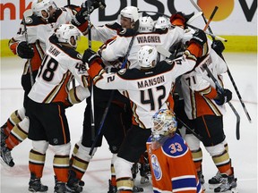 The Anaheim Ducks celebrate after scoring on Oilers goalie Cam Talbot (foreground) in overtime to defeat the Edmonton Oilers by a score of 4-3 in game four of their Stanley Cup playoff series in Edmonton on Wednesday May 3, 2017. The series is now tied 2-2.