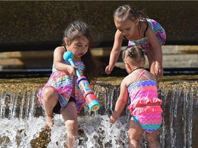 The water is still on the cool side but these girls Jayda Matchee (left), 5 with sister Elise (top), 2 and Elvayeh Powder (right), 1-1/2, still enjoyed themselves in that waterfall at one of the Legislature pools in Edmonton, May 30, 2017.