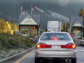 Vehicles slow down to check in at the Jasper National Park gates on highway #16 on Wednesday Oct. 1, 2013.