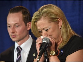 An emotional Shelly MacInnis-Wynn, the widow of Constable David Wynn, responds to the Liberals' defeat of Bill S-217, known as Wynn's Law at Committee during a news conference as MP Michael Cooper looks on in St. Albert, May 12, 2017.