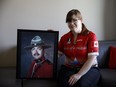 Kimberly McKerry poses with a photo of her late father, Philip McKerry, at her home in Edmonton on Saturday, May 27, 2017. McKerry is riding in the Cycle to Vimy event to honour the fallen and help those with PTSD.