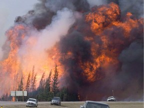 A giant fireball is visible as a wildfire rips through the forest by Highway 63, 16 kilometres south of Fort McMurray, Alta on May 7, 2016. File photo.