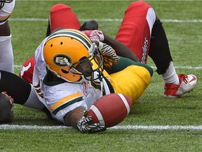 Edmonton Eskimos running back Travon Van reaches the ball across the goal line to score a touchdown against the Calgary Stampeders during a preseason CFL game at Commonwealth Stadium in Edmonton on June 11, 2017.