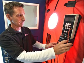 Kent Mohn, vice-president of operations at Sun Ridge, an energy advisory company, demonstrates a pressurized blower door testing for airtightness after the launch of a voluntary EnerGuide for Homes, a new city program aimed at helping homeowners reduce their energy use in Edmonton, June 22, 2017.