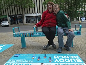 Tommy Kuntz with his grandmother Dianne Kuntz sitting on a bench that is the city's new Buddy Bench pilot project as part of the Hello, How Are You?, a campaign aimed at preventing social isolation, in Edmonton, June 27, 2017.