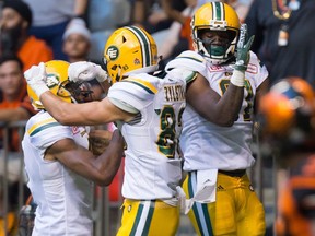 Edmonton Eskimos' Adarius Bowman, from left to right, Brandon Zylstra and D'haquille Williams celebrate Williams' touchdown against the B.C. Lions during the first half of a CFL football game in Vancouver, B.C., on Saturday, June 24, 2017.