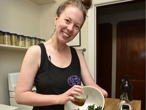 Alexis Hillyard makes a kale, strawberry salad with cranberries, pumpkin seeds and dressing in Edmonton on Saturday, July 2, 2016. She does an amazing YouTube video cooking series called Stump Kitchen. She's missing a hand and is vegan and gluten-intolerant.