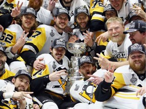 The Pittsburgh Penguins pose for a group photo with the Stanley Cup Trophy after they defeated the Nashville Predators 2-0 in Game 6 of the 2017 NHL Stanley Cup Final at the Bridgestone Arena on June 11, 2017 in Nashville.
