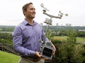 Electronics engineer Marcin Misiewicz with a weather and air quality sensor they're deploying with LoRa Network in Edmonton.