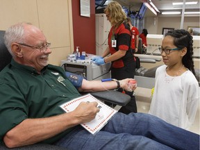 0615 blooddonors

Hosanna Crowell, 11, visits Terry Allison as he makes his 100th blood donation at Canadian Blood Services, 8249  114 St., in Edmonton Wednesday June 14, 2017. Hosanna requires a transfusion every three weeks and is approaching her 200th transfusion. June 14 was World Blood Donor Day.
