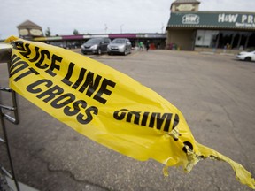 A piece of police tape is tied to a shopping cart in the Kensington Centre, where Joshua Gilbert Barnes was killed on June 18, 2017