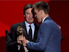 Connor McDavid of the Edmonton Oilers talks with Wayne Gretzky after McDavid wins the Hart Memorial Trophy (Most Valuable Player to His Team) during the 2017 NHL Awards and Expansion Draft at T-Mobile Arena on June 21, 2017 in Las Vegas.