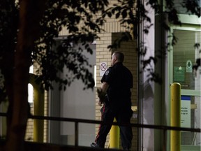 An Edmonton Police Service officer enters the Royal Alexandra Hospital after a shooting victim was dropped off on June 7, 2017. The teenager died of a gunshot wound.