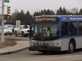 An Edmonton Transit System bus runs through congrested rush hour traffic at the intersection of Terwillegar Drive and 40 Avenue in Edmonton.