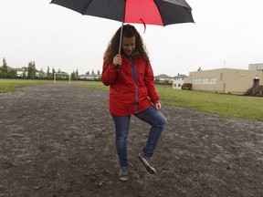 Andrea Jackson, a member of Johnny Bright School's parent advisory council, points out outdoor conditions at the school in Edmonton on Friday, June 2, 2017