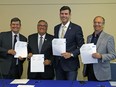 Tom Ruth, president and CEO of Edmonton International Airport, left, City of Leduc Mayor Greg Krischke, Edmonton Mayor Don Iveson and Leduc County Mayor John Whaley hold the signed annexation agreement on June 30, 2017 at Edmonton International Airport between the City of Edmonton and Leduc County.