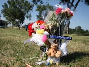 A memorial for Ashton Cardinal, 17, grows in a green space near Parkridge Estates at 29 Street and 116A Avenue in Edmonton on June 26, 2017. Cardinal was identified by family members as the 17-year-old youth found dead in the apartment complex's parking lot on June 23, 2017.