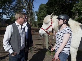 Education Minister David Eggen speaks to Jamie MacDonald prior to announcing new funding for Alberta's Green Certificate Program, which will provide more opportunities for students to explore potential careers in agribusiness. Taken on June 7, 2017, at the Whitemud Equine Learning Centre in Edmonton.