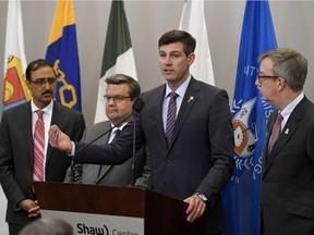 Edmonton Mayor Don Iveson speaks as Federal Minister of Infrastructure and Communities Amarjeet Sohi, left, Montreal Mayor Denis Coderre and Ottawa Mayor Jim Watson, right, look on during a news conference at the Federation of Canadian Municipalities conference in Ottawa on Thursday, June 1, 2017.