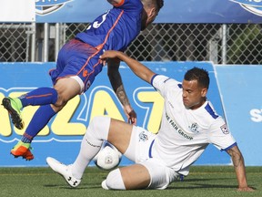 EDMONTON ALBERTA: JUNE 10, 2017. FC Edmonton Shawn Nicklaw (2) slide tackles Miami FC Blake Smith (23) during first half action at Clarke Park. June 10, 2017. JASON FRANSON/EDMONTON JOURNAL. Photos off FC Edmonton game for game story running Sunday, June 11 edition.