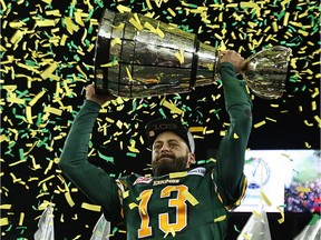 Edmonton Eskimos quarterback Mike Reilly hoists the Grey Cup after defeating the Ottawa RedBlacks in the 2015 CFL championship at Investors Group Field in Winnipeg on Nov. 29, 2015.