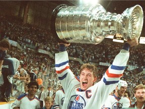 Edmonton Oilers captain Wayne Gretzky hoists the Stanley Cup over his head on May 30, 1985, at Northlands Coliseum after his team beat the Philadelphia Flyers in five games to win the league title.