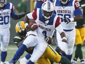 Montreal Alouettes quarterback Darian Durant (4) is tackled by Edmonton Eskimos' Almondo Sewell (90) during first half CFL action in Edmonton on Friday, June 30, 2017.
