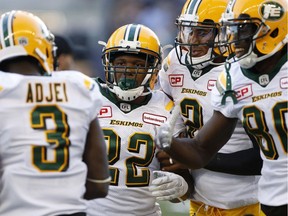 Edmonton Eskimos running back LaDarius Perkins (22) celebrates his touchdown with teammates Natey Adjei (3), quarterback James Franklin (2) and Bryant Mitchell (80) during the first half of CFL action against the Winnipeg Blue Bombers, in Winnipeg on June 15, 2017.