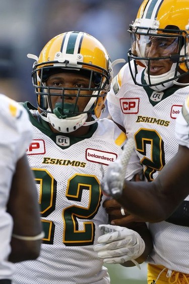 Edmonton Eskimos running back LaDarius Perkins (22) celebrates his touchdown with teammates Natey Adjei (3), quarterback James Franklin (2) and Bryant Mitchell (80) during the first half of CFL action against the Winnipeg Blue Bombers, in Winnipeg on June 15, 2017.