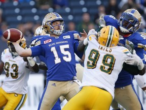 Winnipeg Blue Bombers quarterback Matt Nichols (15) throws under pressure from Edmonton Eskimos' Rykeem Yates (99) during the first half of CFL action in Winnipeg on Thursday, June 15, 2017.