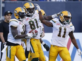 Edmonton Eskimos' D'haquille Williams (81) celebrates his touchdown with teammates Natey Adjei (3) and K.J. Maye (11) during the first half of CFL action against the Winnipeg Blue Bombers, on June 15, 2017.