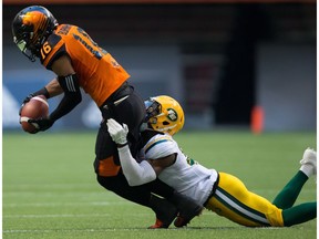 B.C. Lions' Bryan Burnham, left, is tackled by Edmonton Eskimos' Kenny Ladler during the first half of a CFL football game in Vancouver, B.C., on Saturday, June 24, 2017.