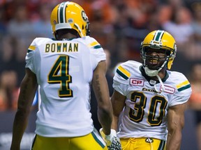 Edmonton Eskimos' John White, right, celebrates his touchdown against the B.C. Lions with teammate Adarius Bowman during the second half of a CFL football game in Vancouver, B.C., on Saturday, June 24, 2017.