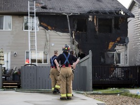 Fire crews clean up after a fire destroyed a duplex at 5615 203 Street on Thursday June 29, 2017, in Edmonton.