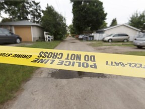 Police discovered a wounded man in an alley near 118 Avenue and 50 Street in Edmonton Friday. The man died on scene. Photo by Ian Kucerak/Postmedia