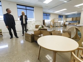 Bishop David Motiuk, left, and principal Terry Volk visit a kindergarten classroom during a tour of at Bishop David Motiuk Elementary/Junior High, a new school set to open in the fall, in Edmonton, Alberta on Tuesday, June 20, 2017.