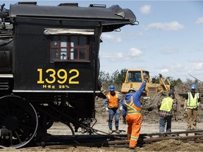 A crew of volunteers and workers with Inter-Rail Transport load a 1913 vintage locomotive on to a truck at the Alberta Railway Museum in Edmonton, Alberta on Wednesday, June 21, 2017. The locomotive will run as part of the Canada Day weekend with another along the Alberta Prairie Railway in Stettler.