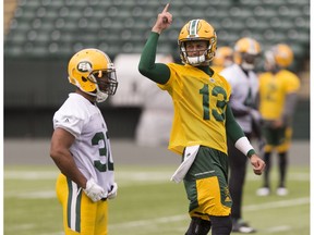 John White (left) and quarterback Mike Reilly are seen during Edmonton Eskimos practice at Commonwealth Stadium in Edmonton, Alberta on Thursday, June 22, 2017.